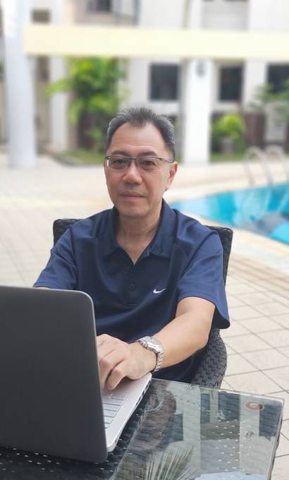 Marcus by the pool with notebook